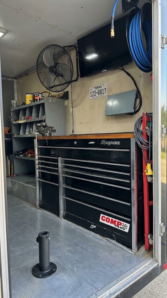 Inside the mobile service unit: tool chest, parts shelving, air hose reel and wall-mounted screen