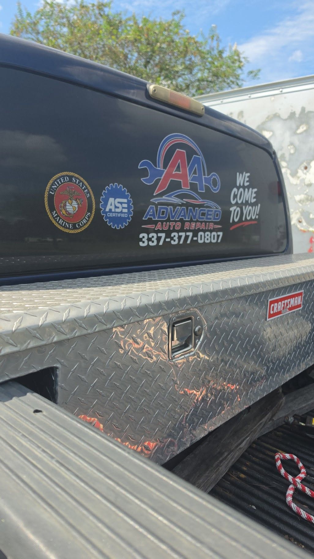 Advanced Auto Repair logo and phone number on Robert’s pickup