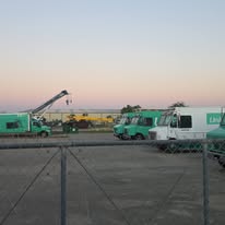 Commercial vehicles parked at an outdoor work location